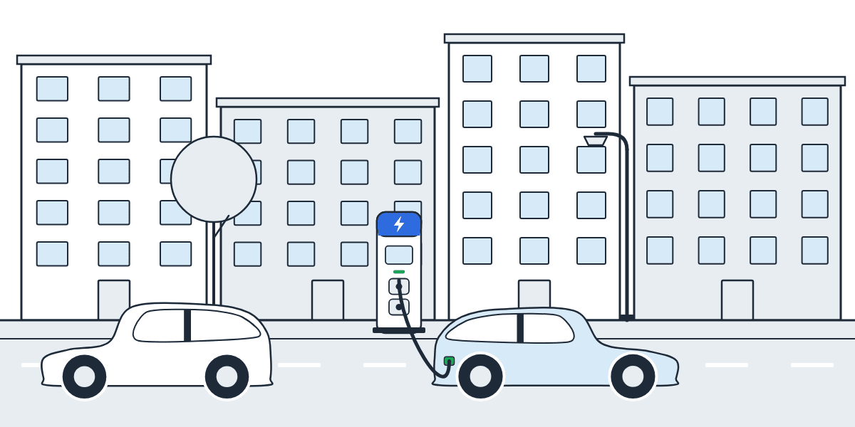 Illustration d'une rue d'immeubles sans parking privé, avec une borne de recharge publique sur le trottoir et une voiture électrique en charge